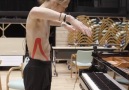 A dancer controls a piano by his movements.