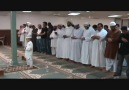 A young Qari of the Quran leading people in Prayer