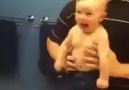 Baby flexes muscles with dad