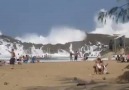 Beach with giant waves protected by a stone wall