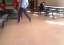 Breakdancing teacher shows students his moves.