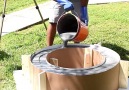 Fire Pit and Grill Top Made From A Washing Machine and Concrete