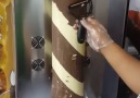Machine rotates cylinder of chocolate