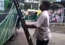 Man climbs a bus carrying bike on head :o