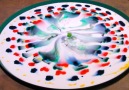 Science helps this tray of milk turn into a magical work of art.