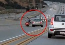 This car tries to run the biker off the road but it doesnt go to plan