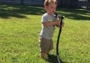 This little boy is having troubles understanding the water hose