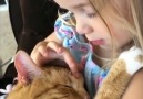 This little girl singing her cat to sleep will melt your heart.