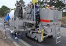 This machine turns concrete into perfect curbs and gutters.