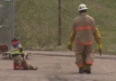 Toddler learns the ropes alongside dad in Firefighter Combat C...