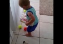 Toddler Struggles To Clean Up Tennis Balls